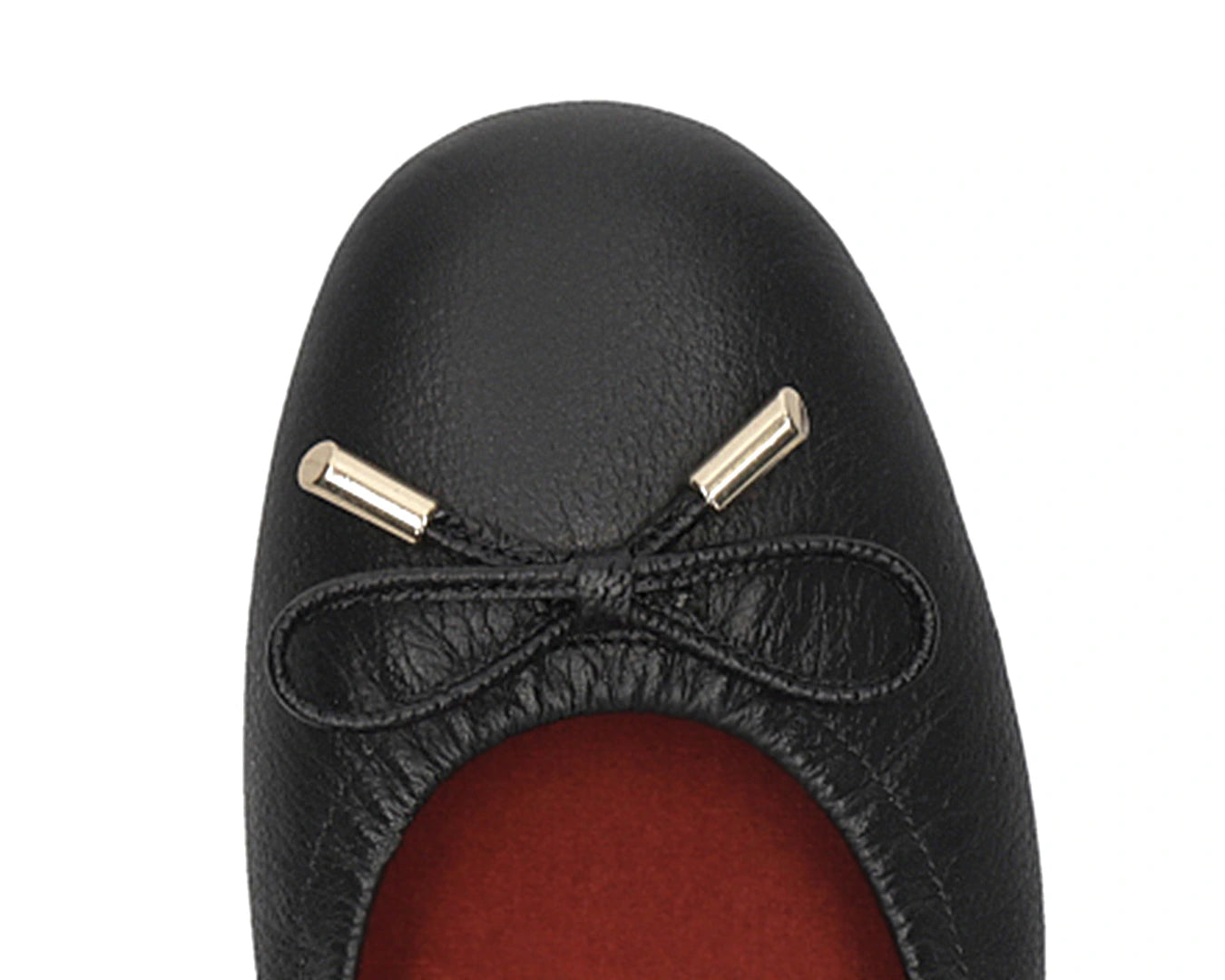 Close-up of the embossed grain leather on Black full-grain leather ballet flats with removable RED ArchSupport orthotic for flat feet, calcaneal spurs, and plantar fasciitis and 24k-gold-plated-bows.