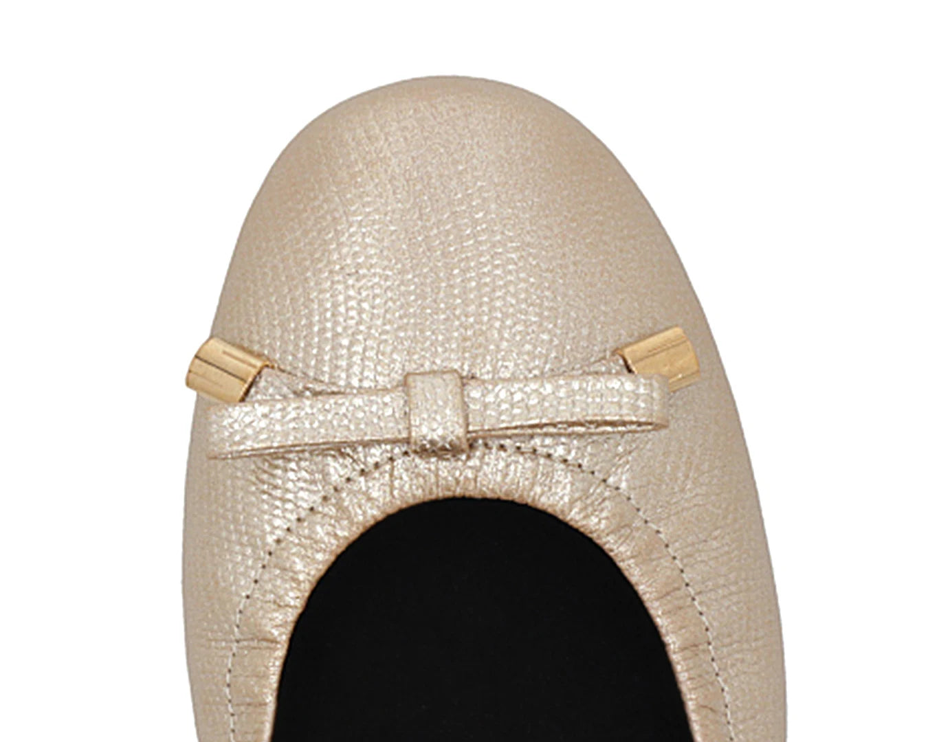 Close-up of gold wild-embossed full-grain leather ballet flats with an elegant bow and gold tips featuring a removable BLACK FlexiComfort orthotic for flat feet.
