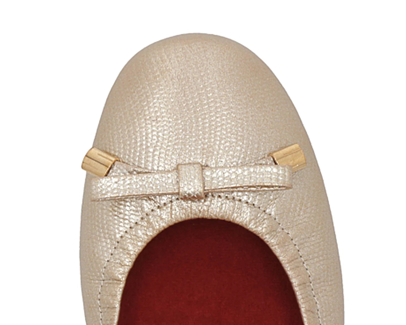 Close-up of gold wild-embossed full-grain leather ballet flats with an elegant bow and gold tips, featuring a removable RED ArchSupport orthotic, designed for flat feet, calcaneal spurs, and plantar fasciitis.