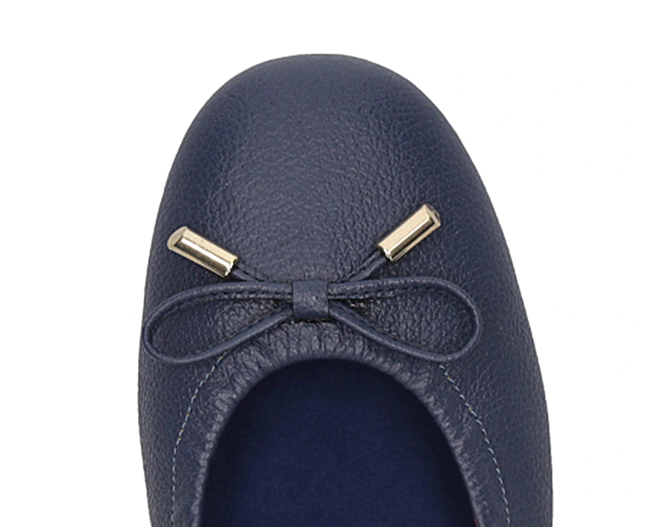 Close-up of the embossed grain leather on navy full-grain leather ballet flats with removable BLUE ComfortFlex orthotic for feet without problems and 24k-gold-plated-bows.