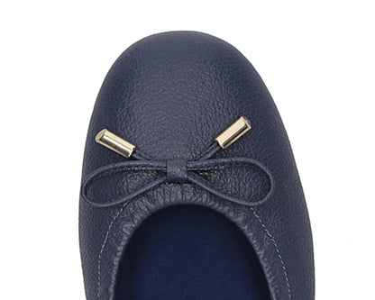 Close-up of the embossed grain leather on navy full-grain leather ballet flats with removable BLUE ComfortFlex orthotic for feet without problems and 24k-gold-plated-bows.