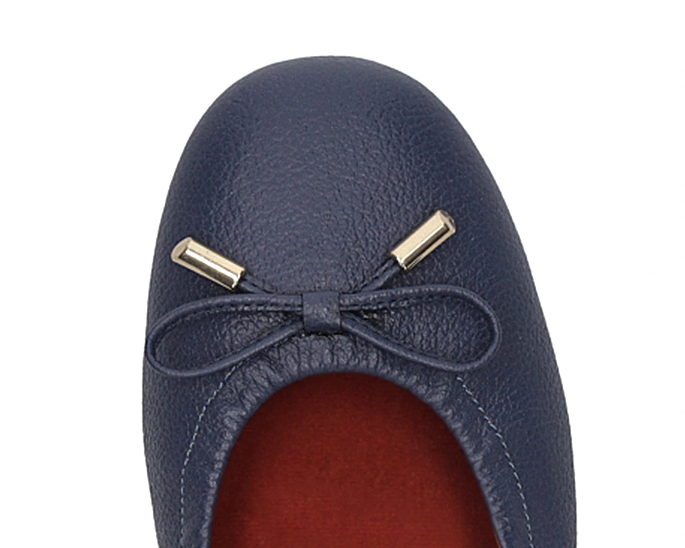 Close-up of the embossed grain leather on navy full-grain leather ballet flats with removable RED ArchSupport orthotic for flat feet, calcaneal spurs, and plantar fasciitis and 24k-gold-plated-bows.