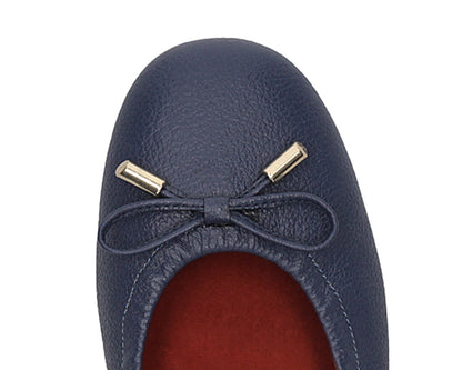 Close-up of the embossed grain leather on navy full-grain leather ballet flats with removable RED ArchSupport orthotic for flat feet, calcaneal spurs, and plantar fasciitis and 24k-gold-plated-bows.