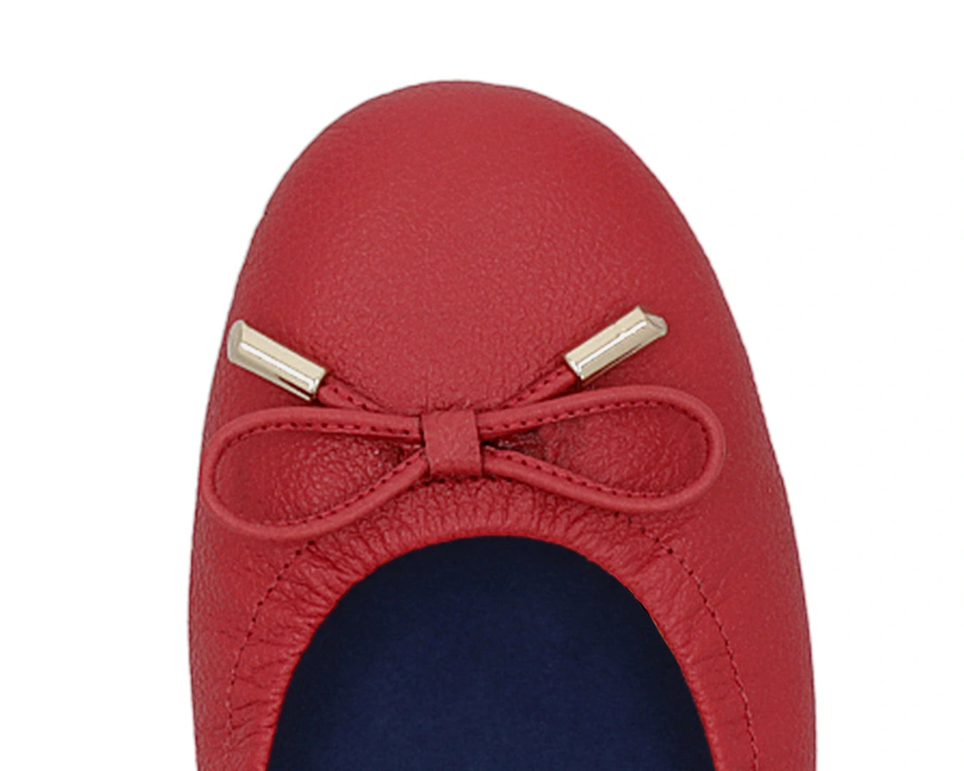 Close-up of the embossed grain leather on red full-grain leather ballet flats with removable BLUE ComfortFlex orthotic for feet without problems and 24k-gold-plated-bows.