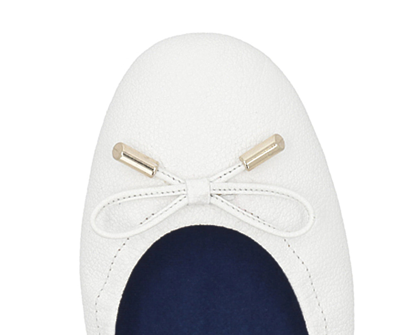 Close-up of the embossed grain leather on White full-grain leather ballet flats with removable BLUE ComfortFlex orthotic for feet without problems and 24k-gold-plated-bows.